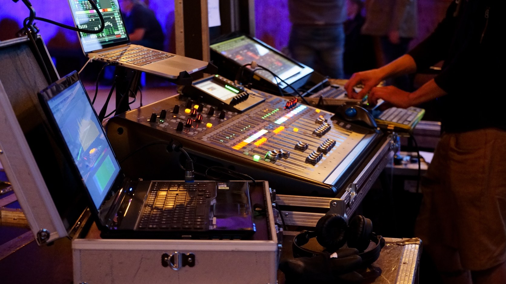 Audio mixing console and laptop during a live production