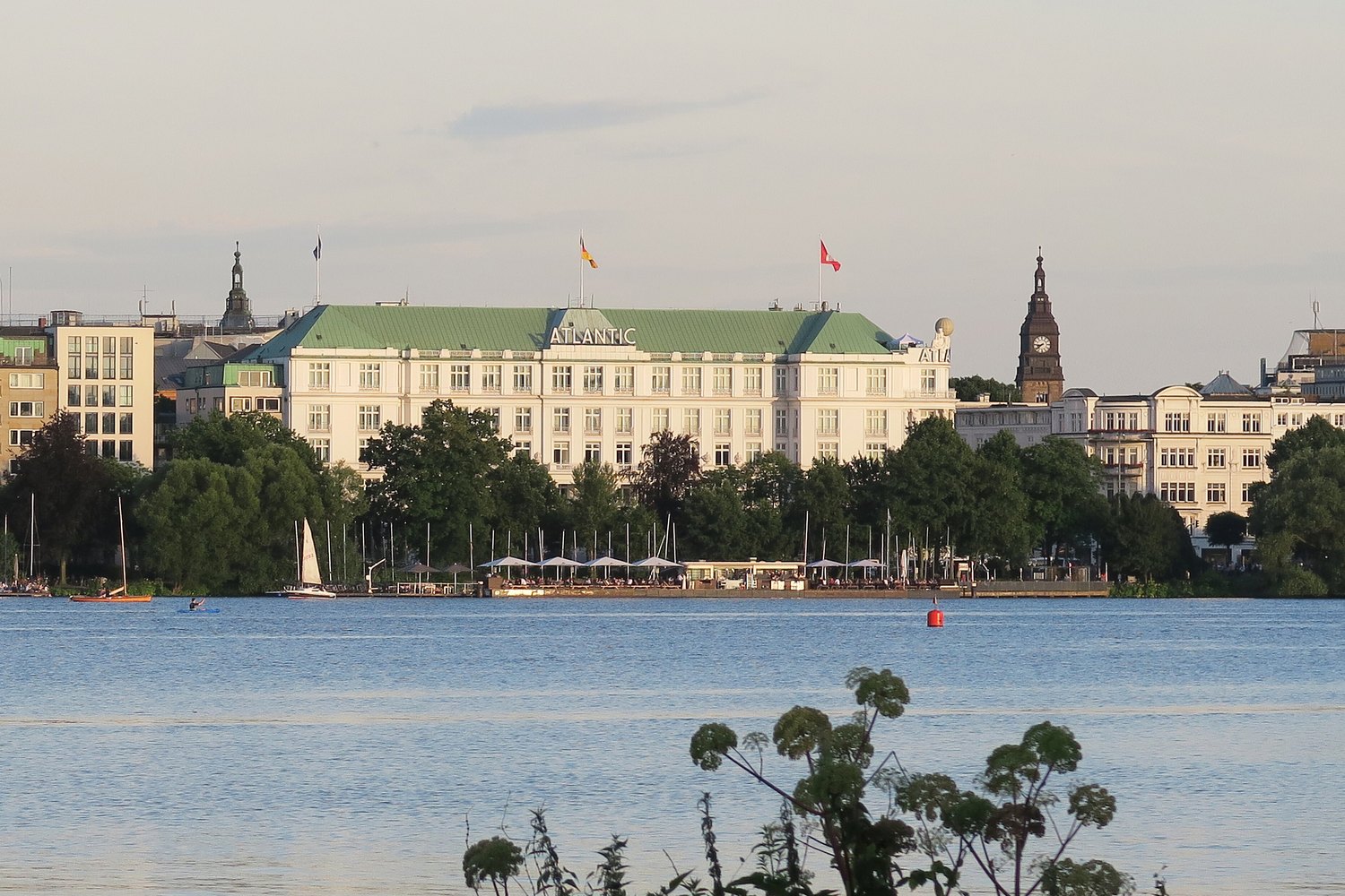 White facade of Hotel Atlantic beside Hamburg's Outer Alster lake