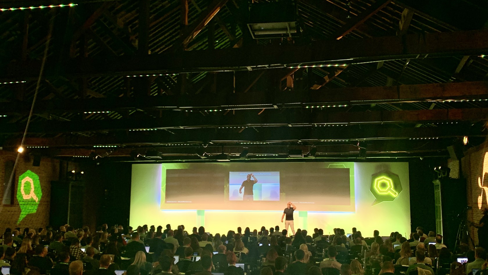 Keynote speaker addressing a large audience at a marketing conference