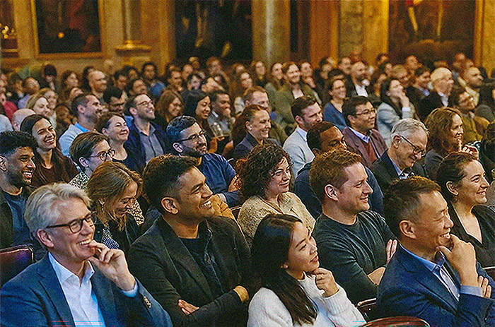 Laughing audience at an AI keynote in Frankfurt, Germany